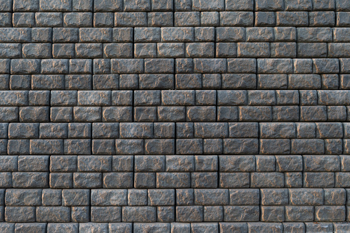 Wide view of rows of gray retaining blocks forming a large wall.