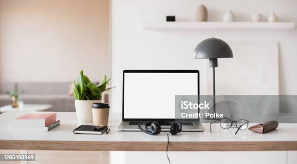 Place Of Work Laptop With Blank Empty Screen Coffee Headset Glasses At Home Desk Stock Photo - Download Image Now