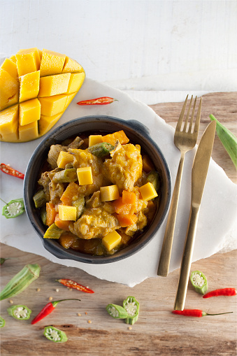 Chicken curry plat with mango.