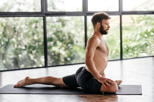 istock Yoga men workout in studio in front of a window 1285455888