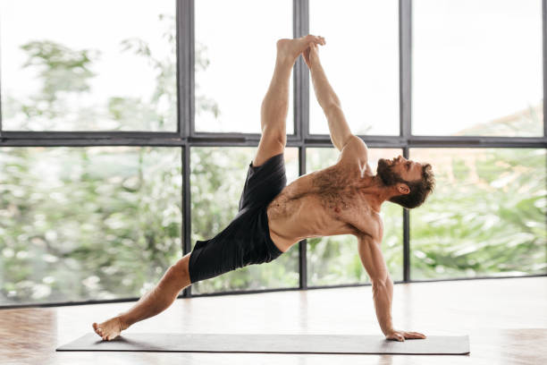 istock Yoga men workout in studio in front of a window 1285455895