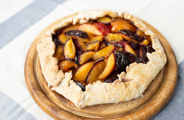 istock Plum biscuit. Sliced ​​delicious plums for the filling. 1285456828