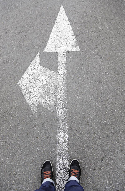 istock Directional arrow on the asphalt with a few feet 1285457071