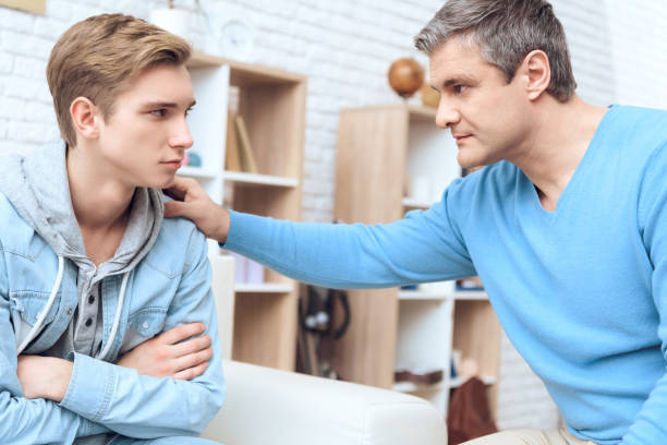 Father tries to talk to his son, and troubled teenager begins to listen. stock photo