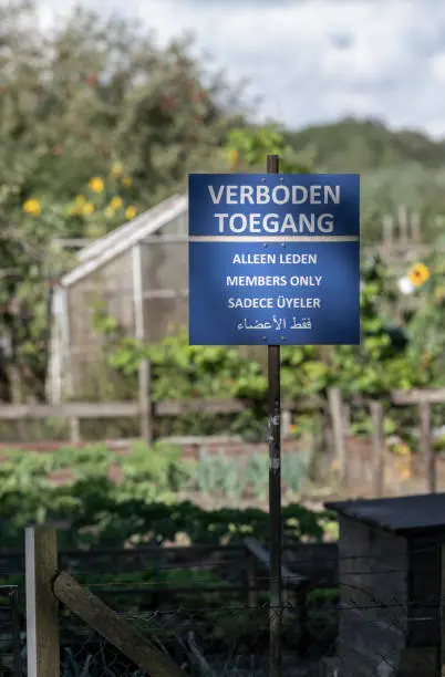 Forbidden access only for members sign in Dutch and several languages in a blue color at allotments