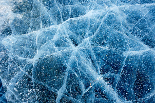 Beautiful blue ice of Lake Baikal with cracks.