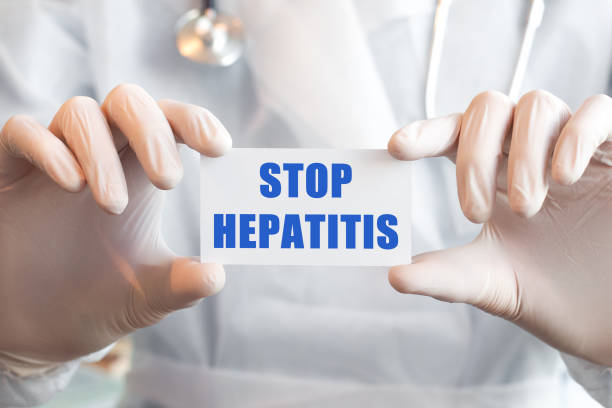 istock Doctor holding a card with text STOP HEPATITIS 1285461436