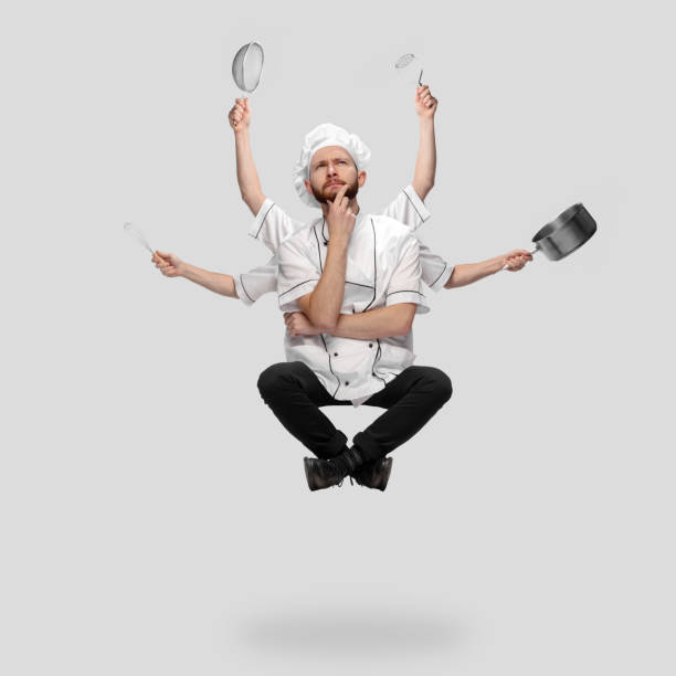 istock Cooker, chef, baker in uniform multitask like shiva isolated on gray studio background 1285461543