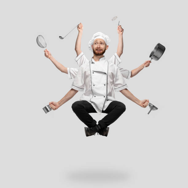 istock Cooker, chef, baker in uniform multitask like shiva isolated on gray studio background 1285461551