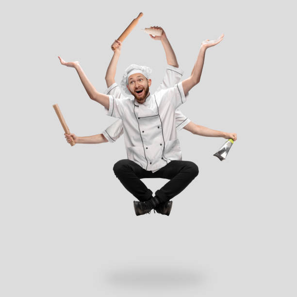 istock Cooker, chef, baker in uniform multitask like shiva isolated on gray studio background 1285461567