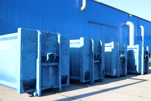 Blue waste containers in a large hangar
