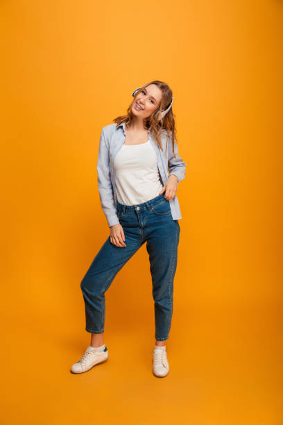 istock Smiling young lady standing listening music 1285464113