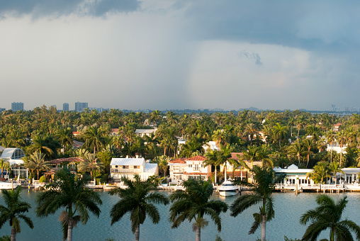 The view at dusk of a rainy sky and residential Palm Island in Miami (Florida).