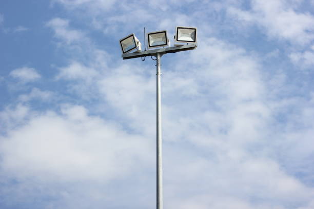 istock Spotlight pole, Power poles and sport light with blue sky and clouds background. 1285466477