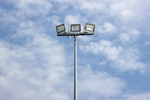 istock Spotlight pole, Power poles and sport light with blue sky and clouds background. 1285466538