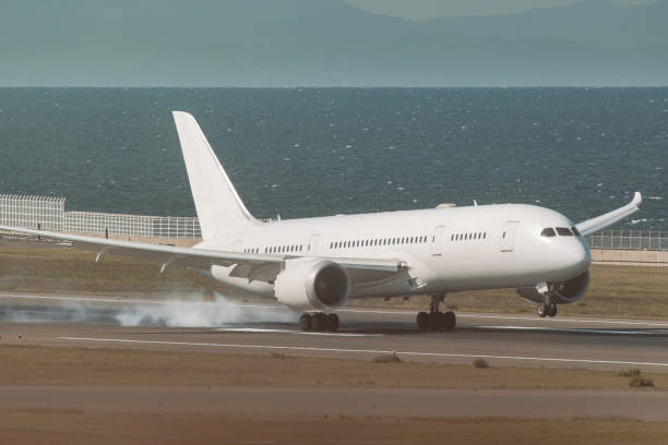 istock white airplane landing in haze afternoon with ocean background 1285466580