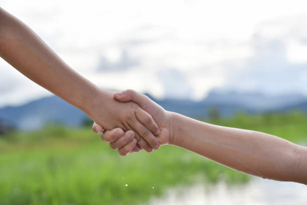 Close up shaking hands isolated on white