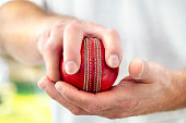 istock Cricket fast bowler holding ball close up 1285468776