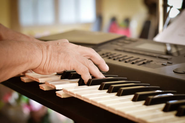 istock Close-up of a musician playing piano keyboard. 1285469730
