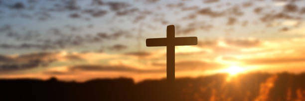 istock Silhouette of catholic cross at sunset background 1285469883