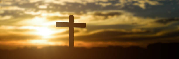 istock Silhouette of catholic cross at sunset background 1285469936
