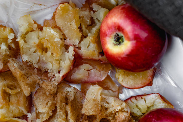 istock Collapsed soft baked apples in a white ceramic square shape on a special package. A white tablecloth is laid carelessly on the table, 1285469958