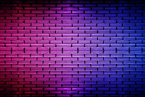 Lighting effect neon light on brick wall texture for background.