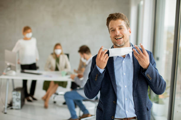 istock Handsome young business man putting his protective facial mask 1285471332