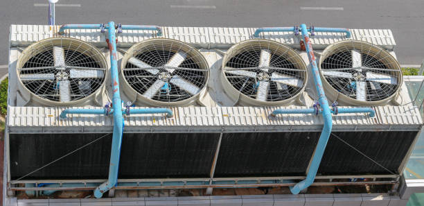 istock View from above on industrial ventilation with spinning blades or air conditioning system on roof building in Asia. Cooling system in tropical climate 1285472655