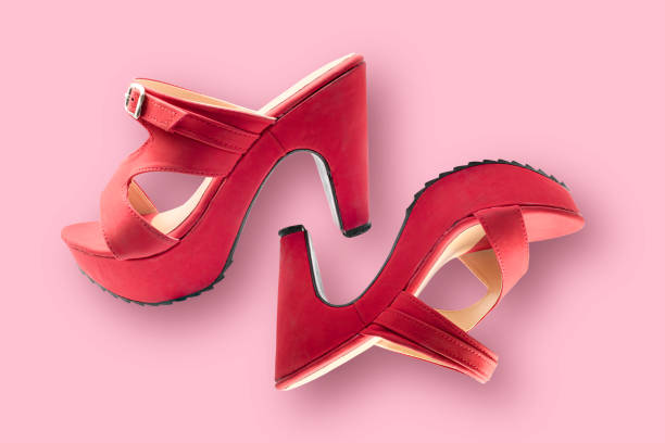 istock Red shoes high heels isolated on a pink background 1285472705