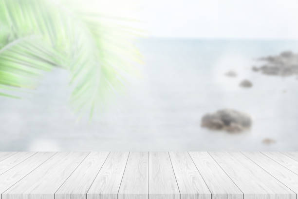 istock Perspective empty white wooden table on top over blur summer background. 1285474310