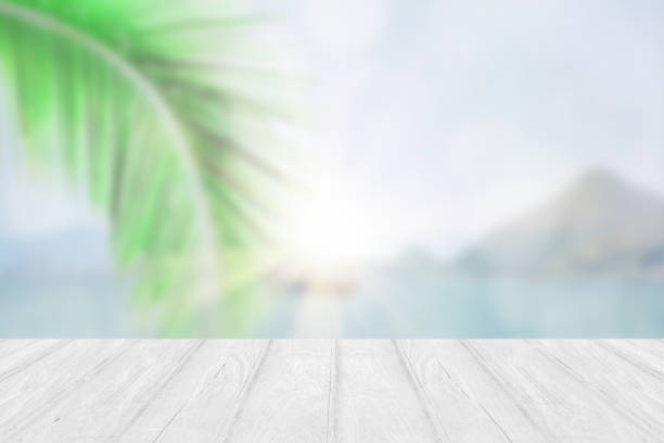 istock Perspective empty white wooden table on top over blur summer background. 1285474326