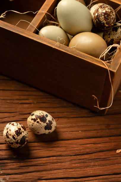istock Wooden containers of egg and quail eggs on the table 1285474464