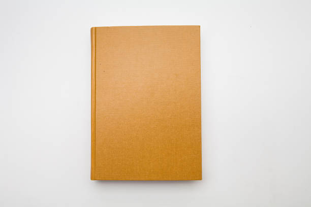 istock Gold color blank book on white background 1285476720