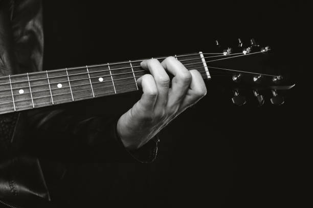 istock musician with guitar black and white 1285477982
