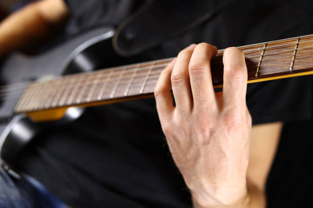 istock guitarist playing guitar, hands closeup 1285478143