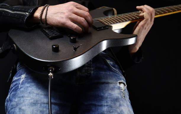 istock guitarist plays an electric guitar solo with a pick 1285478176