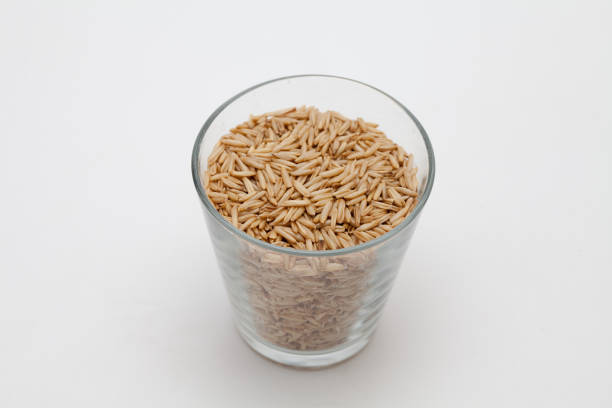 istock Oats in a transparent cup on white background 1285478204