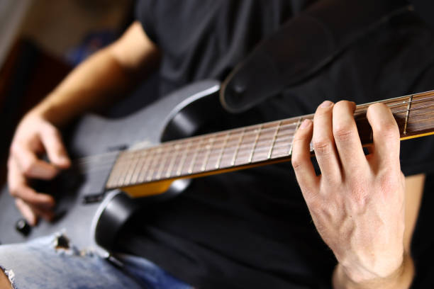 istock guitarist playing guitar, hands closeup 1285478487