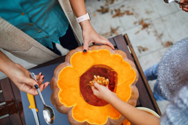 istock Mother And Her Daughter Making Jack O' Lantern 1285479606