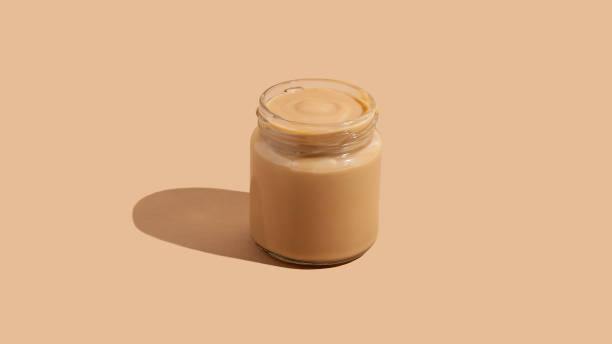 istock Yogurt pudding dessert in glass jar on beige background with copy space 1285481461