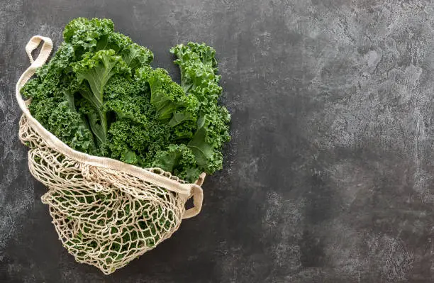 Green Kale or leaf cabbage in a string bag. A great source for vitamins K and D also contains Ca. good for cooking stew or chips or smoothie.