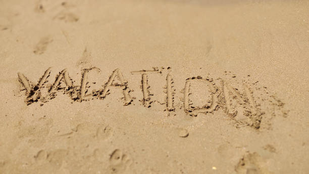 istock Text Vacation written in the sand of sea beach 1285482580