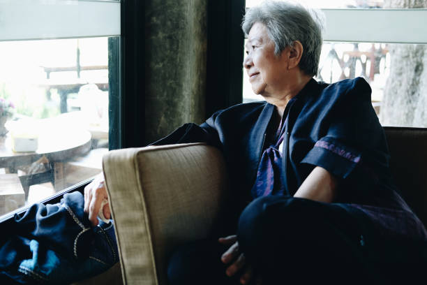 istock asian elder woman resting relaxing on sofa. elderly senior leisure lifestyle 1285483032