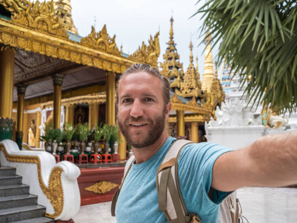 istock Man takes selfie with gold temple in Myanmar 1285484372