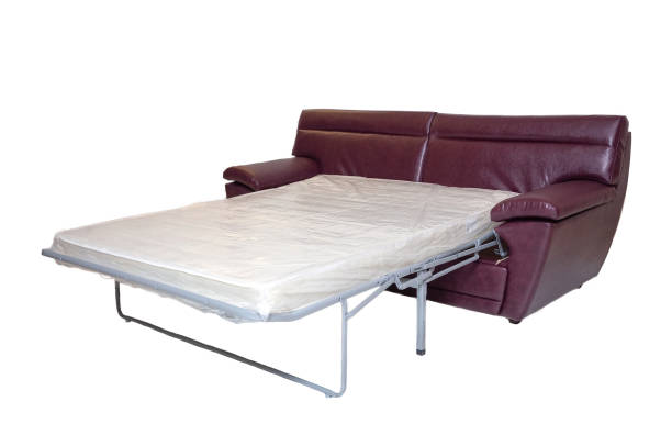 istock leather sofa with extended mattress for sleeping isolated on white. modern couch 1285484559