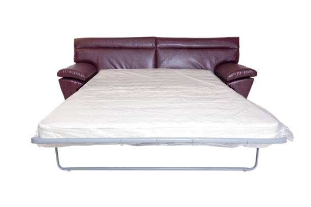 istock leather sofa with extended mattress for sleeping isolated on white. modern couch 1285484568