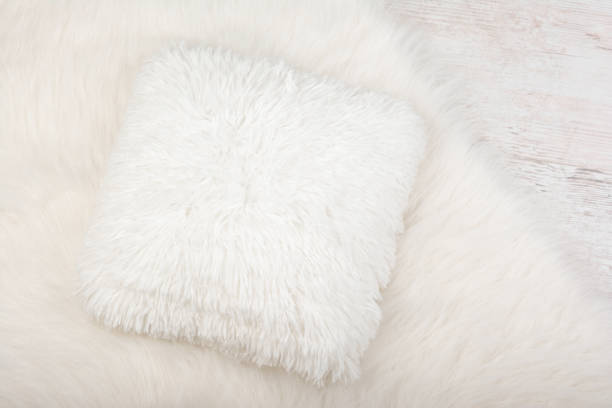 White shaggy carpet and cozy pillow background. Home interior background.
