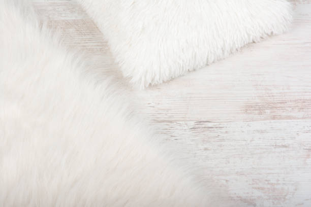 istock White shaggy carpet and cozy pillow background. Home interior background 1285485779