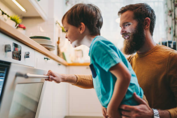 istock Father with son cooking dinner at home 1285486109